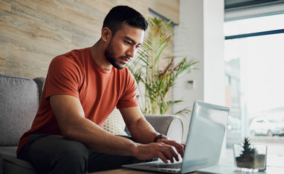 Guy booking a tele health visit for testosterone replacement Therapy TRT on his laptop